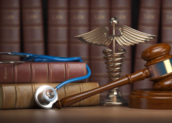 Gavel, stethoscope and caduceus sign on books background. Mediicine laws and legal, medical jurisprudence. 3d illustration