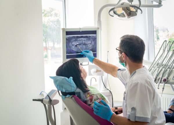 Doctor dentist showing patient's teeth on X-ray