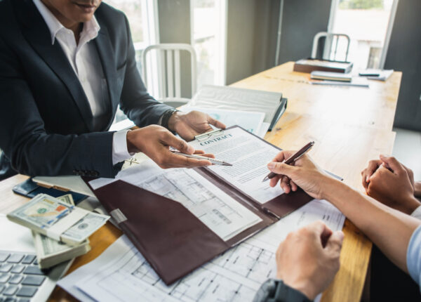 Customer signing contract documents for realty purchase, Bank employees congratulate, Concept mortgage loan approval. Business loan from a bank employee. finance concept .