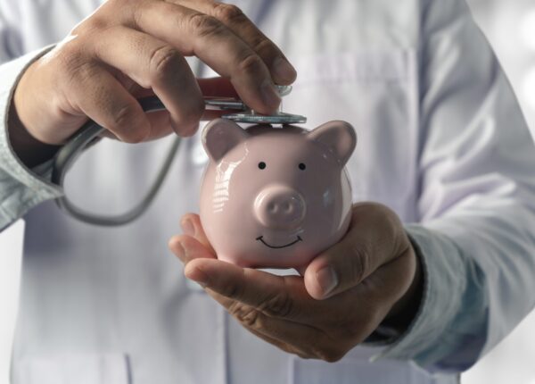 Doctors medical saving money on health care insurance to insurance plan finance Piggy bank money