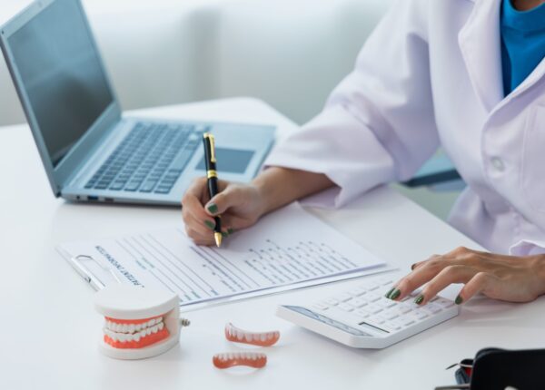 oral dentistry Female dentist in machine talking with male patient on table in clinic, dental model, dental health care according to prescription