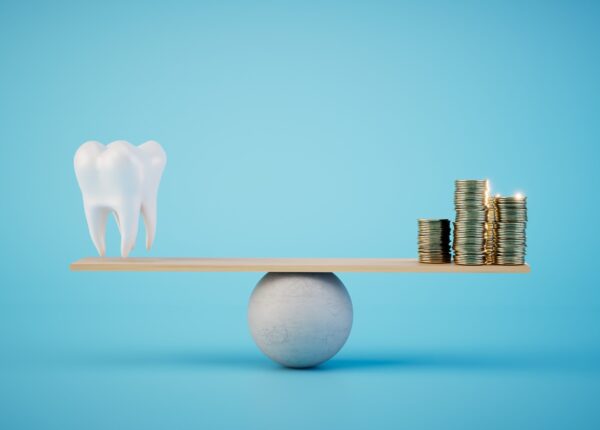 the cost of dental treatment corresponds to the quality. scales on which a tooth and stacks of coins. 3D render.